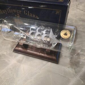 Hand-crafted Mayflower Glass ship in a bottle with a wooden base. Santa Maria
